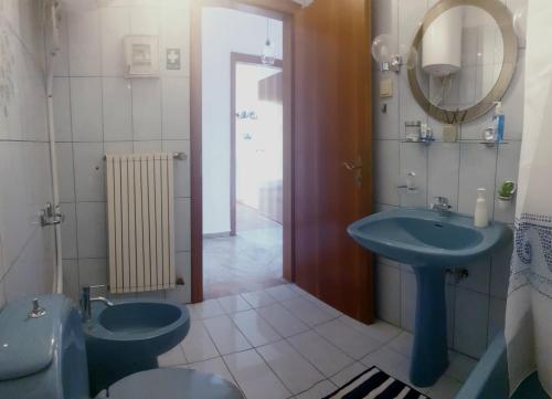 y baño con 2 aseos, lavamanos y espejo. en Cozy 100qm 3 Bedroom Apartment en Kerkíni