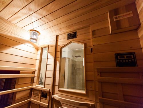 a small room with a mirror and a wooden wall at Hôtel Spa Marotte in Amiens