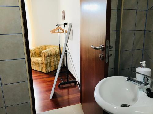 a bathroom with a sink and a mirror at Casa do Lugar da Ribeira in Ribeira Brava