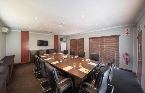 a conference room with a large table and chairs at Birchwood Hotel and OR Tambo Conference Centre in Boksburg