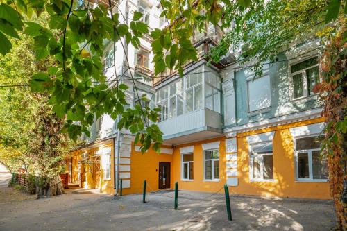 a large yellow building with windows on a street at The Key in Kyiv