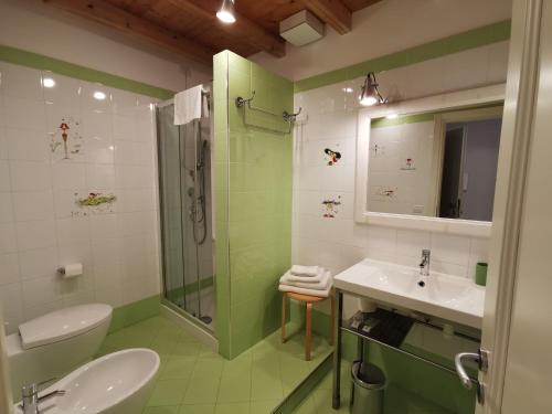 a green and white bathroom with a sink and a shower at B&B Re Umberto in Milazzo