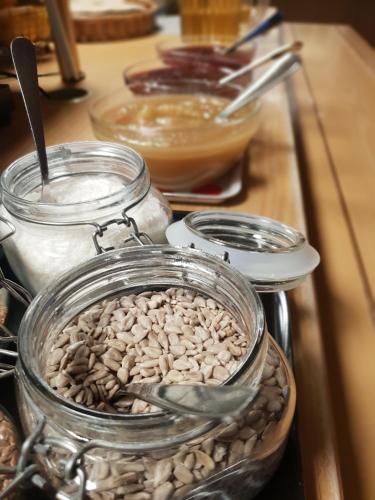 a glass jar filled with nuts on top of a counter at Nordiska Folkhögskolan Bed and Breakfast in Kungälv