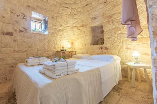 Postel nebo postele na pokoji v ubytování Trullo del Mandarino con piscina