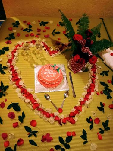 a table with a heart shaped cake on a table at TAGBALAYON Lodging House in Siquijor