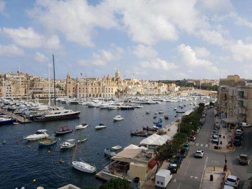 a harbor with boats in the water and buildings at Entire Senglea Seaview Town house in Senglea