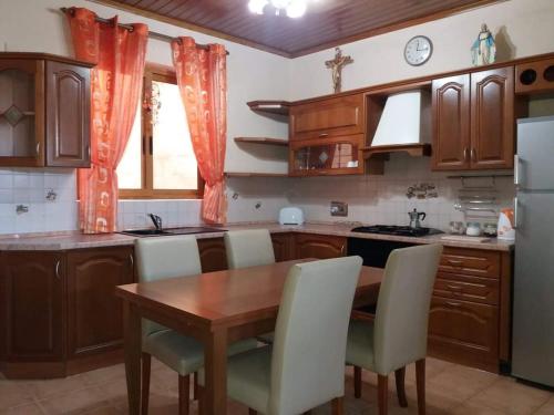 a kitchen with a table and chairs and a refrigerator at Entire Senglea Seaview Town house in Senglea