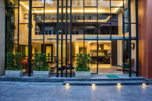 a large building with some plants in front of it at Aim House Bangkok No Parking in Bangkok