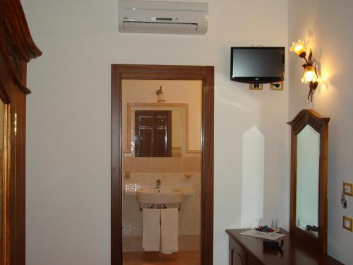 a bathroom with a sink and a mirror at Brezza Marina in San Vito lo Capo