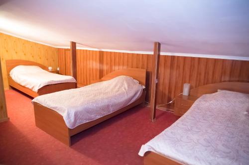 a hotel room with two beds and two tables at Europa in Ulyanovsk
