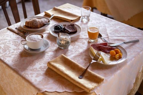 a table with breakfast foods and drinks on it at Hotel La Fattoria Sul Mare in Capo Vaticano