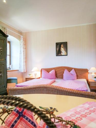 a bedroom with two beds with pink pillows at Almbauernhof in Ruhpolding