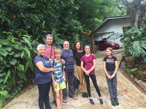 a family posing for a picture in front of a house at White Lodge in Kandy