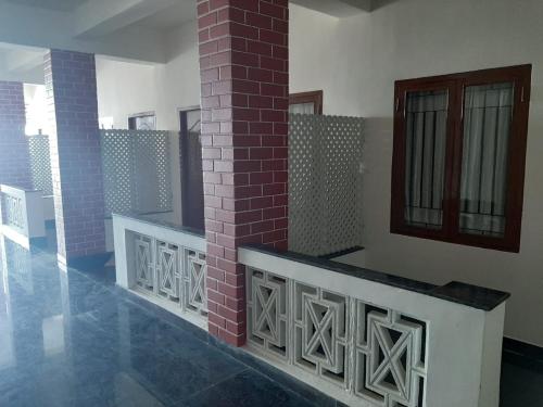 a room with a brick wall and a brick pillar at BAY INN in Chennai