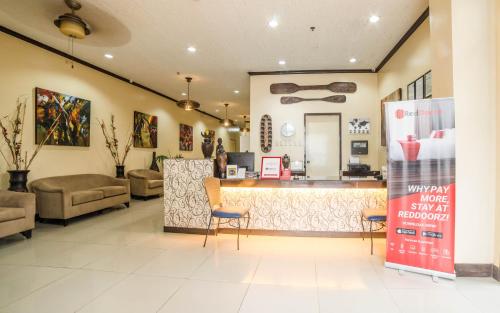 a waiting room with chairs and a counter in a store at RedDoorz Plus near Rizal Junction in Puerto Princesa City