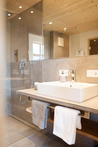 a bathroom with a white sink and a mirror at Haus FreiRaum in Fischen