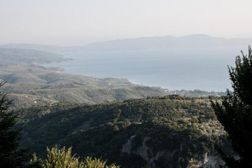 a view of a hillside with a body of water at Pelion House with Wonderful View in Vizitsa