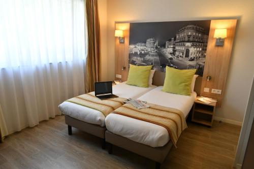 Katil atau katil-katil dalam bilik di Appart-Hôtel Mer & Golf City Bordeaux Bassins à flot