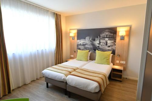 Katil atau katil-katil dalam bilik di Appart-Hôtel Mer & Golf City Bordeaux Bassins à flot