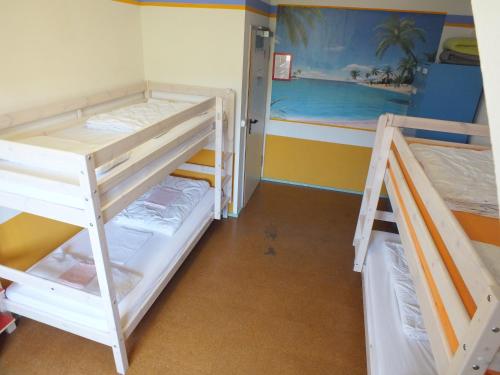 a bedroom with two bunk beds in a room at Max Hostel in Bonn