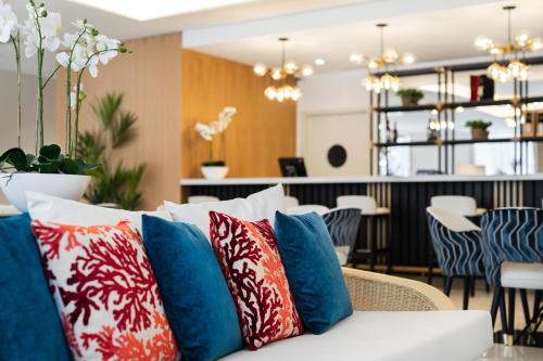 a white couch with blue and red pillows at Eurostars Matosinhos in Matosinhos