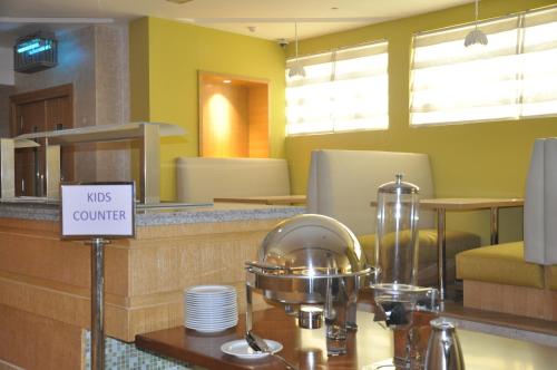 a restaurant counter with a sign that reads was courage at Lavender Hotel Al Nahda Dubai in Dubai