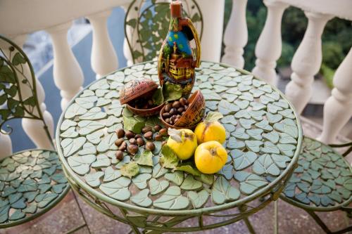 a table with a bottle of wine and fruit on it at Dat Exx Apartments On Liberty Square in Tbilisi City