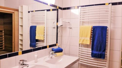 Apartments Stegmühle في ماوترندورف: حمام مع حوض ومرآة ومناشف