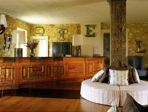 a living room with a bed and a tv at Albergo l'Ostelliere - Villa Sparina Resort in Gavi