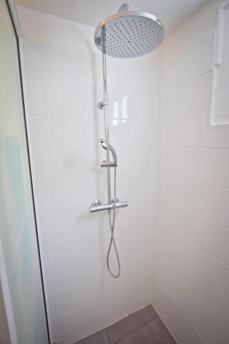 a shower with a shower head in a bathroom at Duplex 4 personnes Chambre vue mer Résidence O Coeur de Deshaies in Deshaies