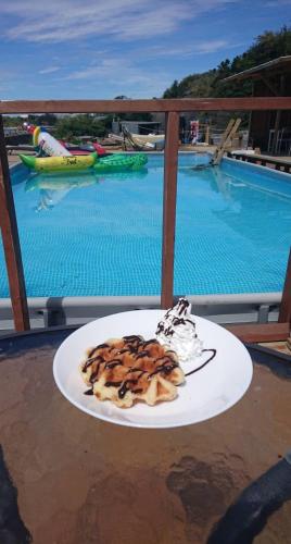 a plate of food on a table next to a pool at MARINE-Q in Inami