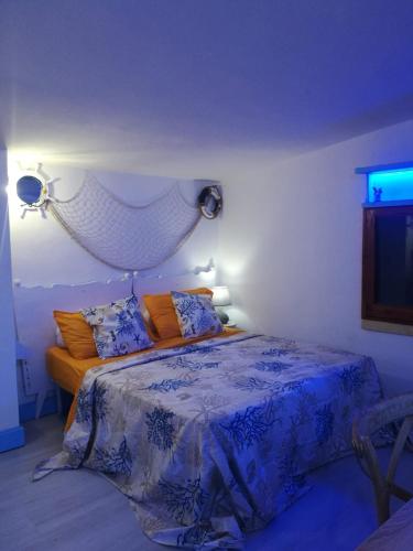 a bedroom with a bed with a blue comforter at La Terrazza on Acquaviva in Marittima