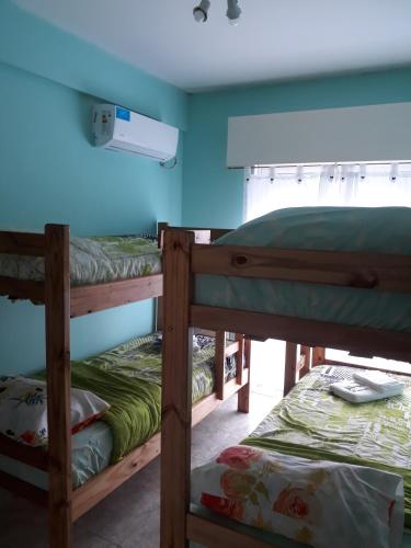 two bunk beds in a room with a blue wall at Departamentos Devoto in Buenos Aires