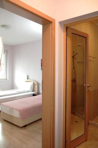 a bedroom with a glass door leading to a shower at BLOCK 531 ApartHouse BLOCK 533 in Sofia