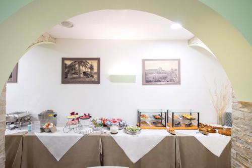 a table with a white table cloth in a room at Ibis Styles Palermo Cristal in Palermo