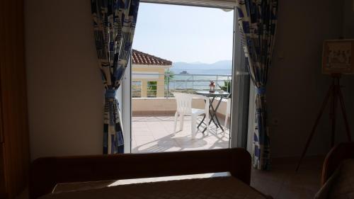 a door to a balcony with a view of a patio at Villa with the view of Palamidi and Bourtzi in Nafplio