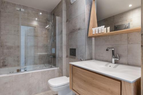 a bathroom with a sink and a toilet and a shower at Annapurna by Alpine Resorts in Les Gets