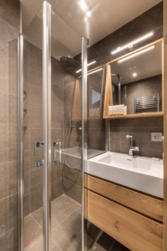 a bathroom with a sink and a shower at Annapurna by Alpine Resorts in Les Gets