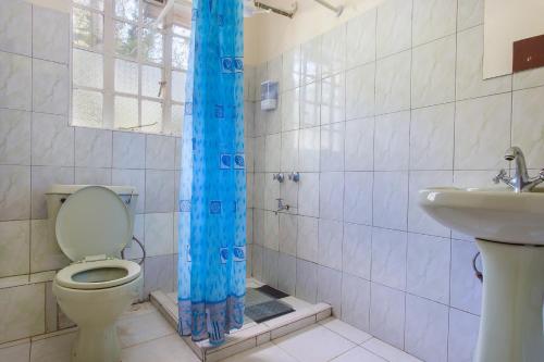 a bathroom with a toilet and a sink at Convent International Hotel- Nairobi in Nairobi