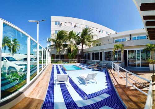 a large building with a swimming pool on a cruise ship at FPH Hotel in Aracaju