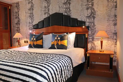 a bedroom with a bed with a black and white comforter at Fredrick's Hotel Restaurant Spa in Maidenhead
