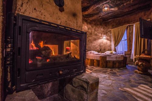 a fireplace in a room with a fire in it at Royal Valentina Castle in Ognyanovo