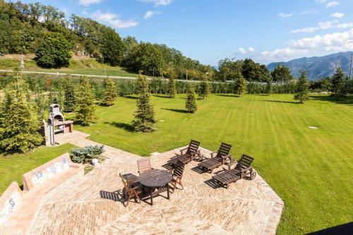 a group of chairs and tables in a field at ALTIDO Superb Villa with Tennis Court, Garden and BBQ area in Valle
