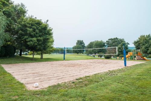 a volleyball court in a park with a net at The Suites at Fall Creek in Branson