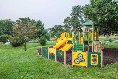 a playground with a slide in a park at The Suites at Fall Creek in Branson