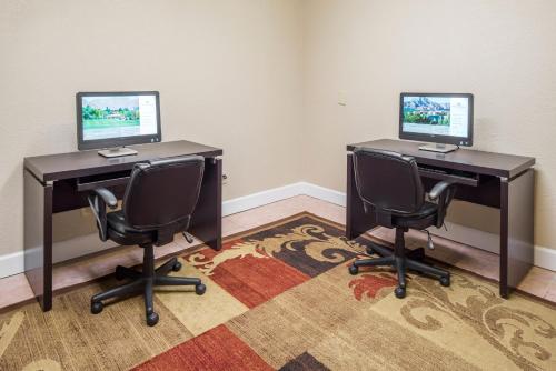 two desks with two computers on them in a room at The Suites at Fall Creek in Branson