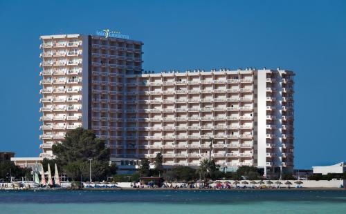 un gran edificio junto a la playa con gente delante en Hotel Izán Cavanna, en La Manga del Mar Menor