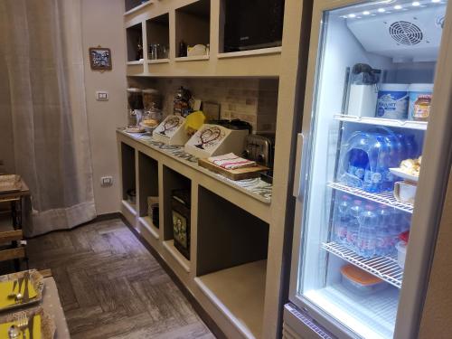 a refrigerator with its door open in a kitchen at Guesthouse Luisella in Cagliari