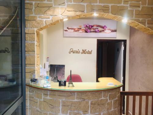 an office with a stone wall with a desk at Paris Hôtel Le Mediterraneen in Paris