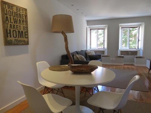 a living room with a table and chairs at Belém 25, duplex apartment in Lisbon